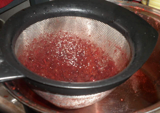 Straining the strawberry juice. 